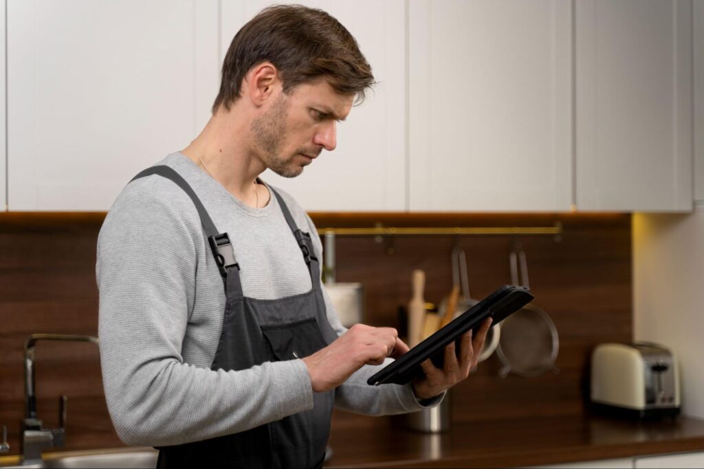 Professional technician inspecting a fridge to check refrigerator cooling and diagnose why refrigerator is not cooling properly.

